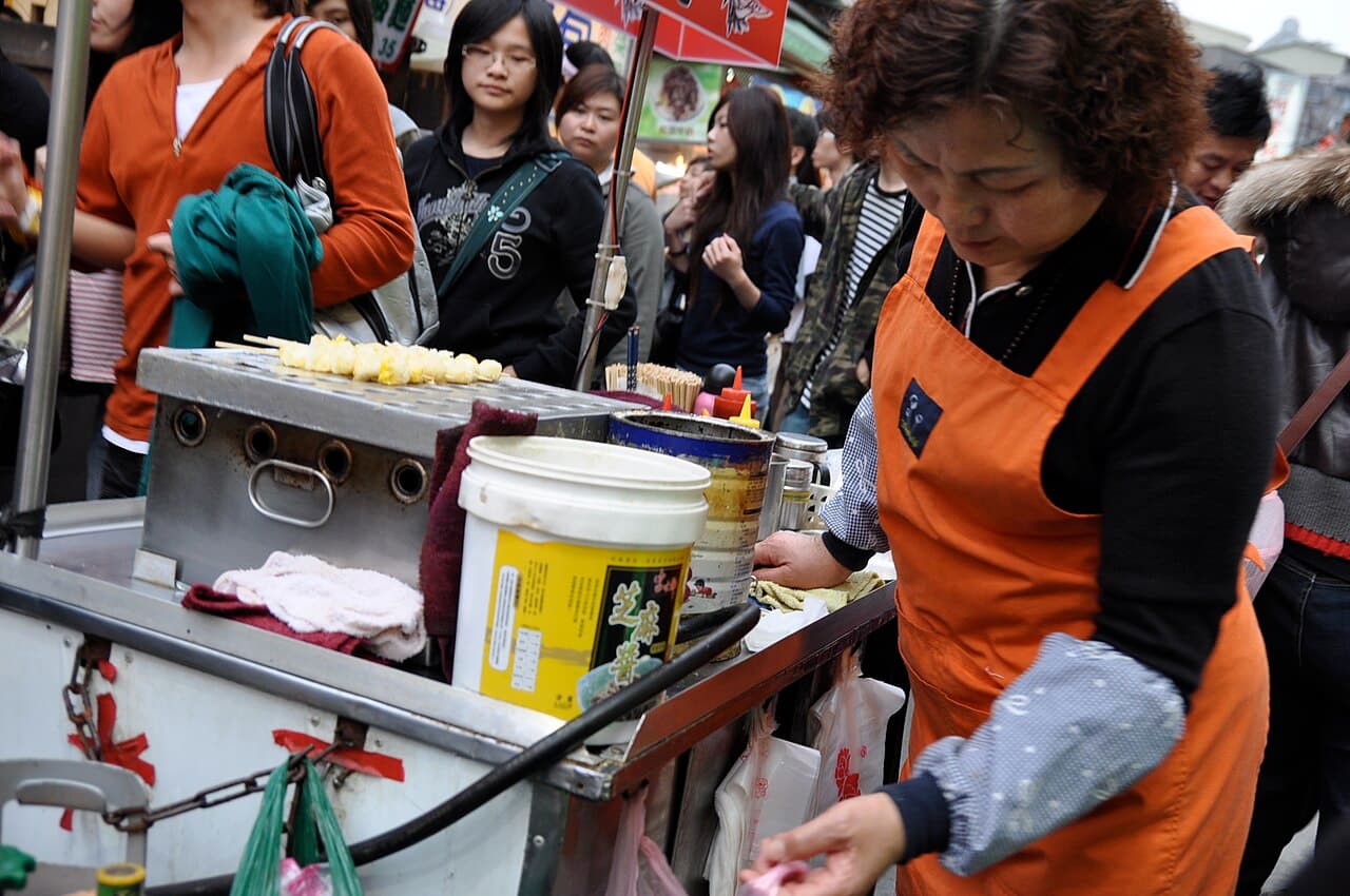 A food vendor cooking at a stall in the Shilin Night Market in Taipei.